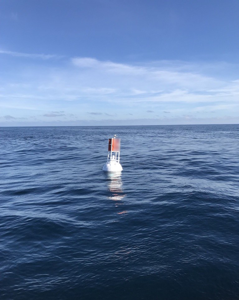 58-14 buoy, a 58 x 14 steel channel marker buoy with light and orange and white dayboard tower, on station in open water
