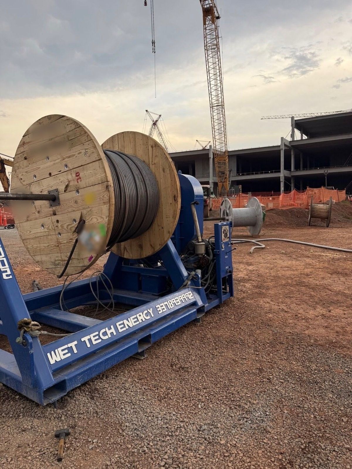 Wet Tech RS-002 spooling unit with a wooden cable reel at a construction jobsite
